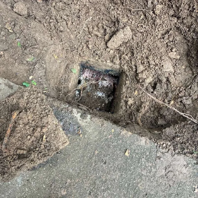 Excavated sewer line access point during a drain cleaning job near Tahlequah