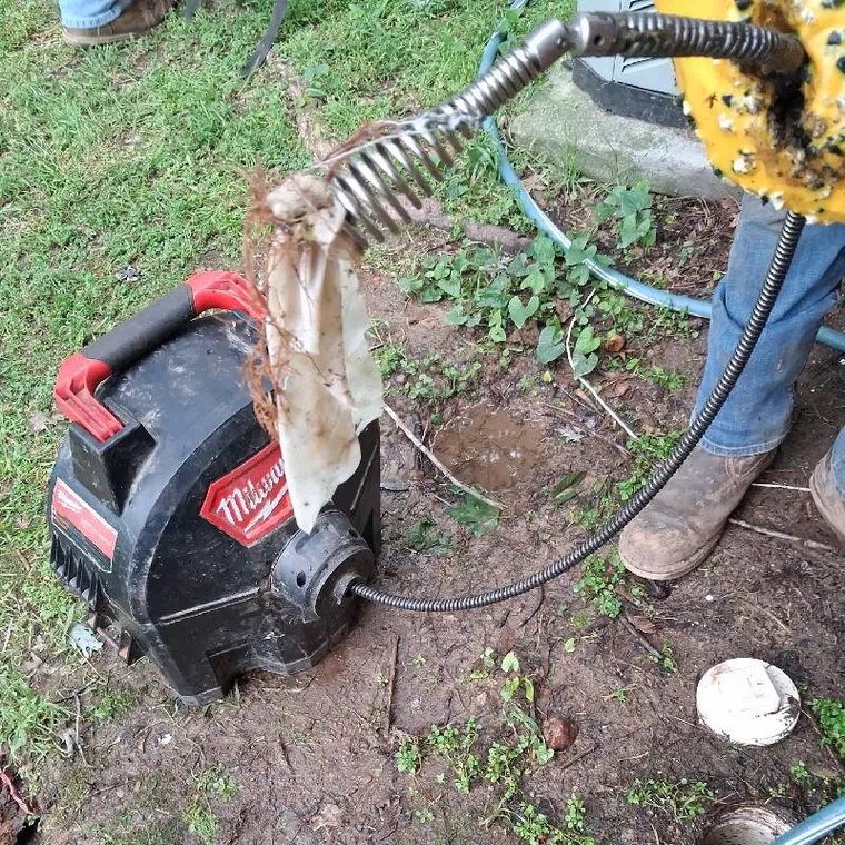 Drain cleaning machine removing baby wipes and roots from an outside cleanout in Tahlequah