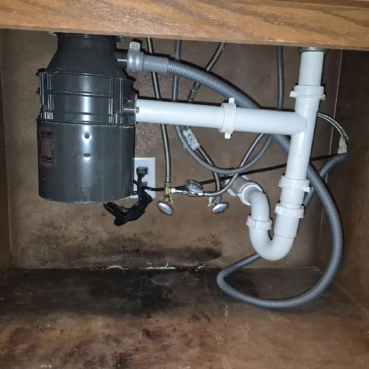 Rebuilt kitchen drain assembly under a sink for a plumbing job in Muskogee, OK by Clog Hunter.