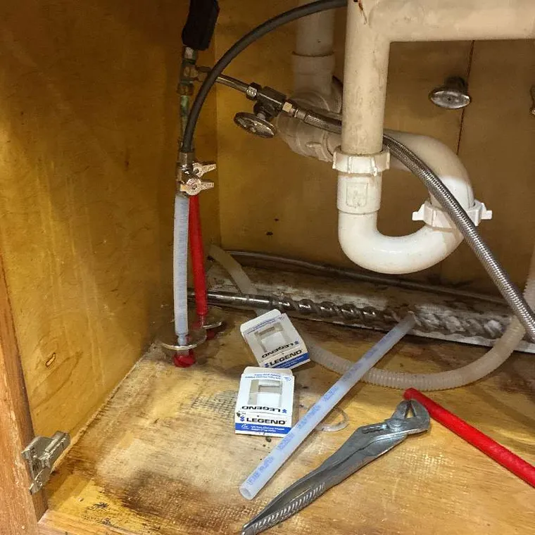 Under sink plumbing connections during sewer line repair and reroute work in Tahlequah OK