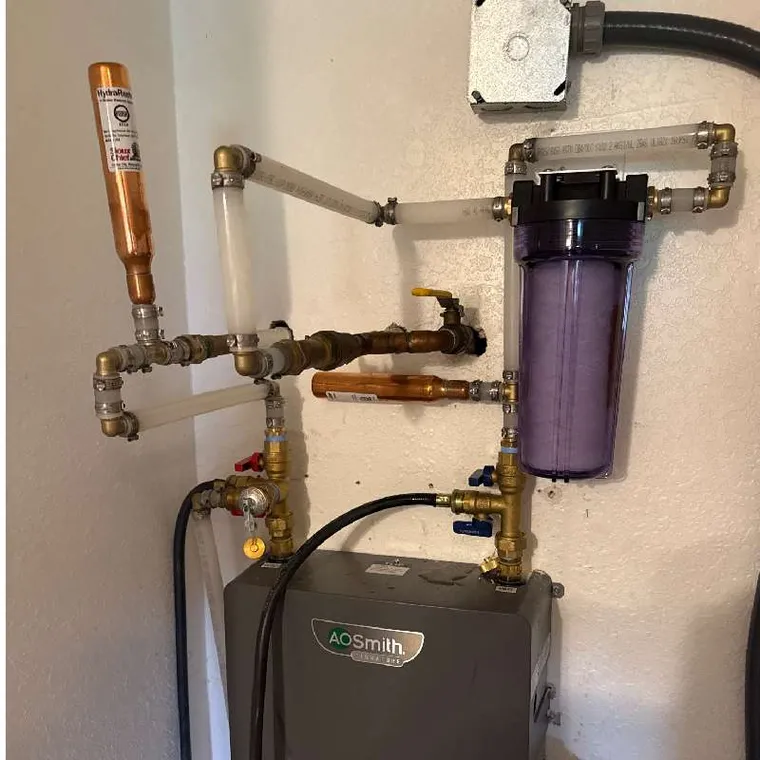 Tankless water heater flush setup and plumbing connections during service in Tahlequah, OK.