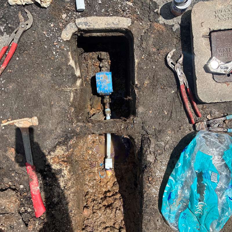 Plumbing repair work near a water meter box in Muskogee, OK