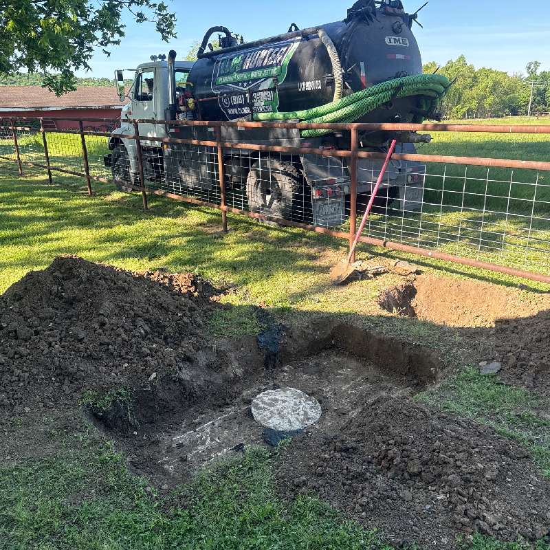 Septic pumping service in Muskogee, OK with Clog Hunter truck and exposed septic tank access