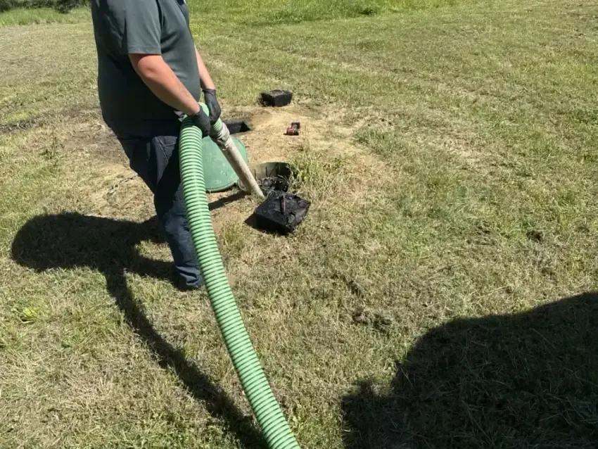 Clog Hunter pumping a septic tank with a vacuum hose in Eastern Oklahoma