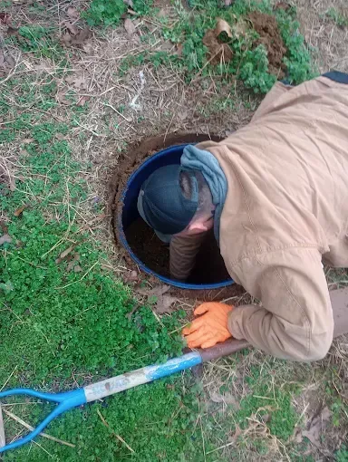 Clog Hunter repairing a septic system component on a rural Eastern Oklahoma property